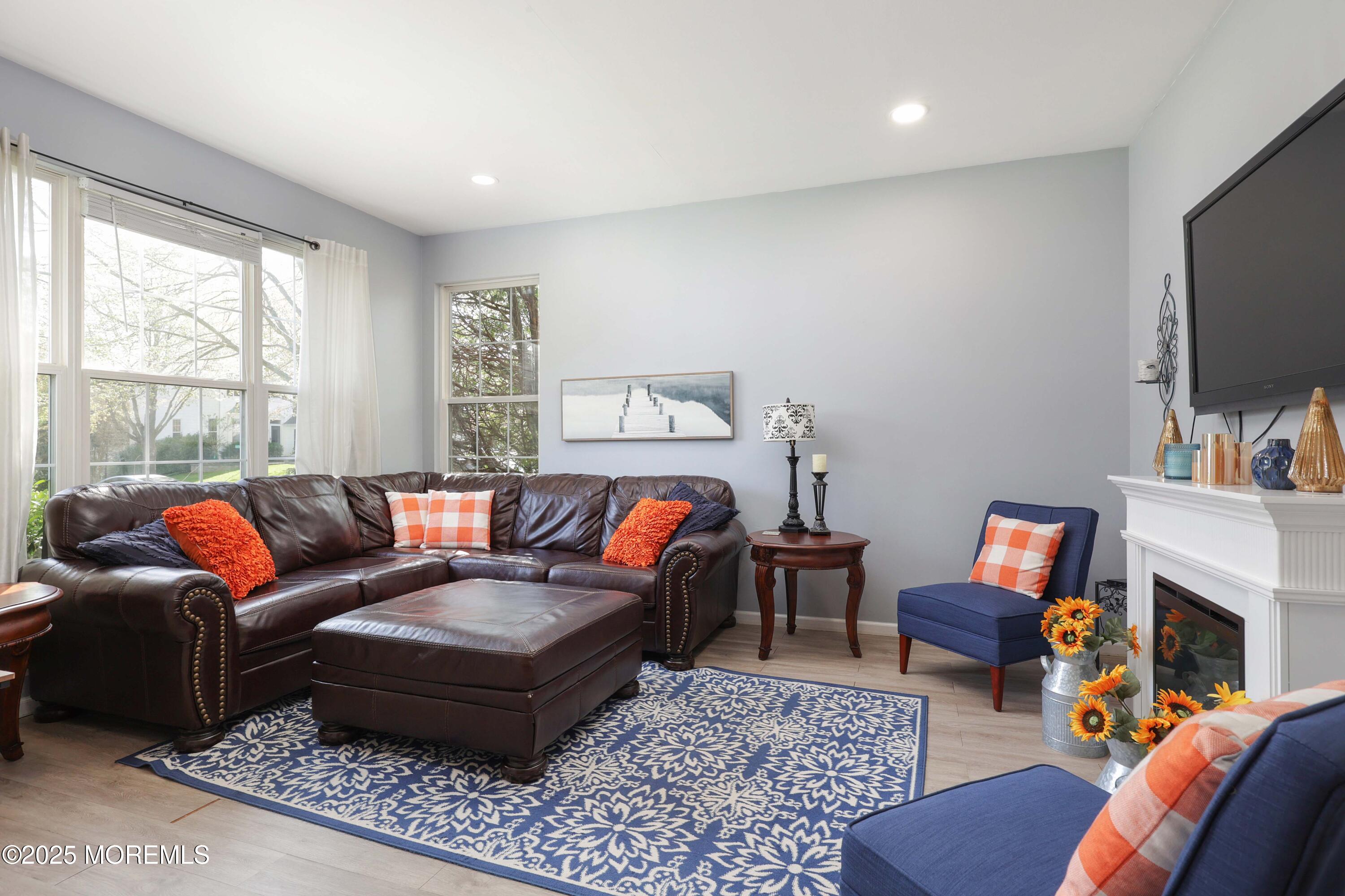1 Exeter Pass Colts Neck, NJ 07722 - Photo 2 of 42 a living room with furniture a rug and a flat screen tv