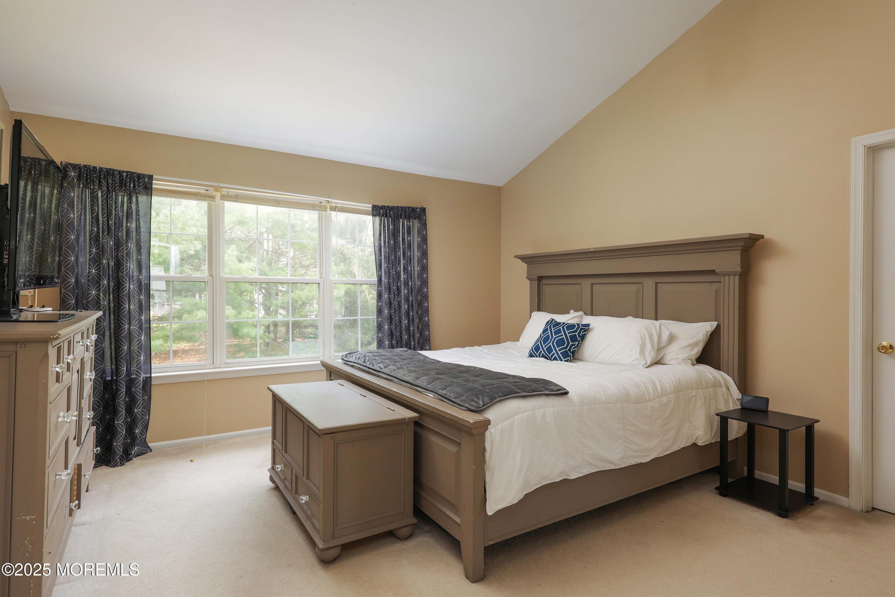 1 Exeter Pass Colts Neck, NJ 07722 - Photo 23 of 42 a bed sitting in a bedroom next to a window