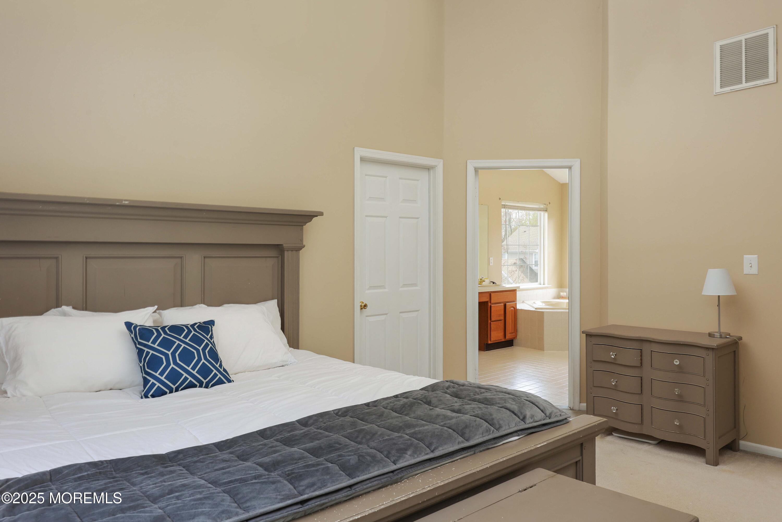 1 Exeter Pass Colts Neck, NJ 07722 - Photo 24 of 42 a bedroom with a bed and wooden floor