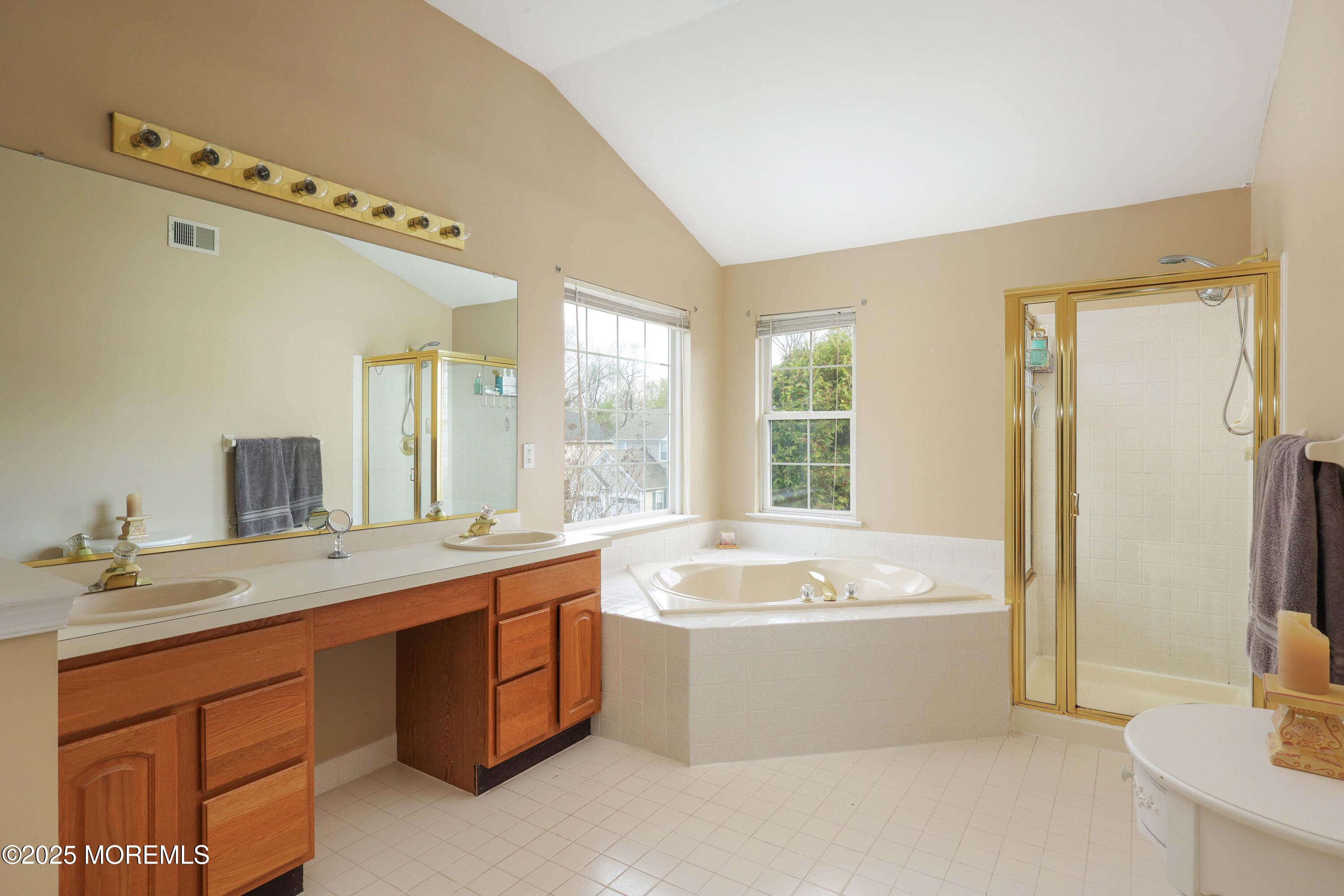 1 Exeter Pass Colts Neck, NJ 07722 - Photo 26 of 42 a view of a bathroom with a tub double sink mirror and