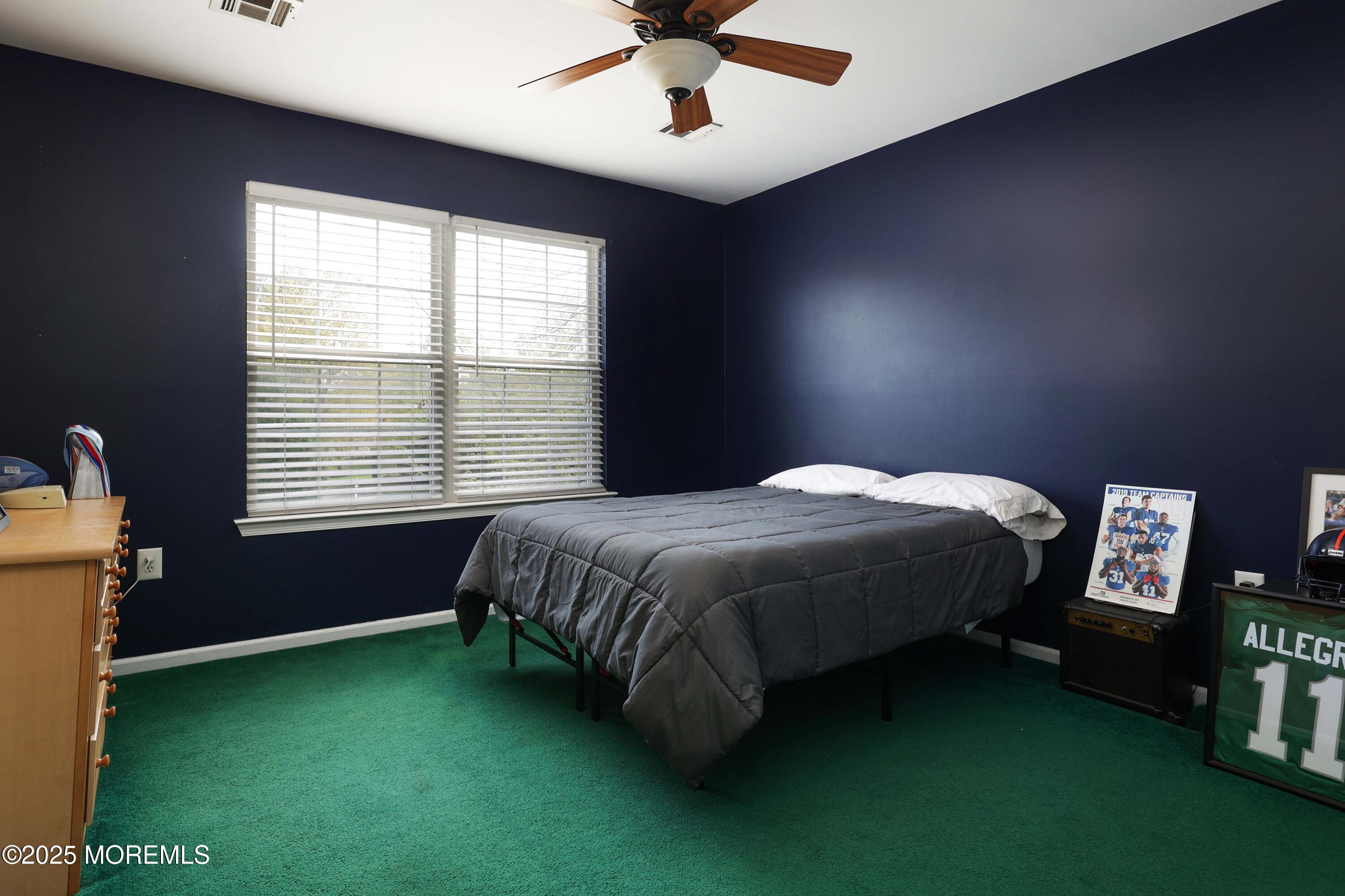 1 Exeter Pass Colts Neck, NJ 07722 - Photo 27 of 42 a spacious bedroom with a bed and a chandelier