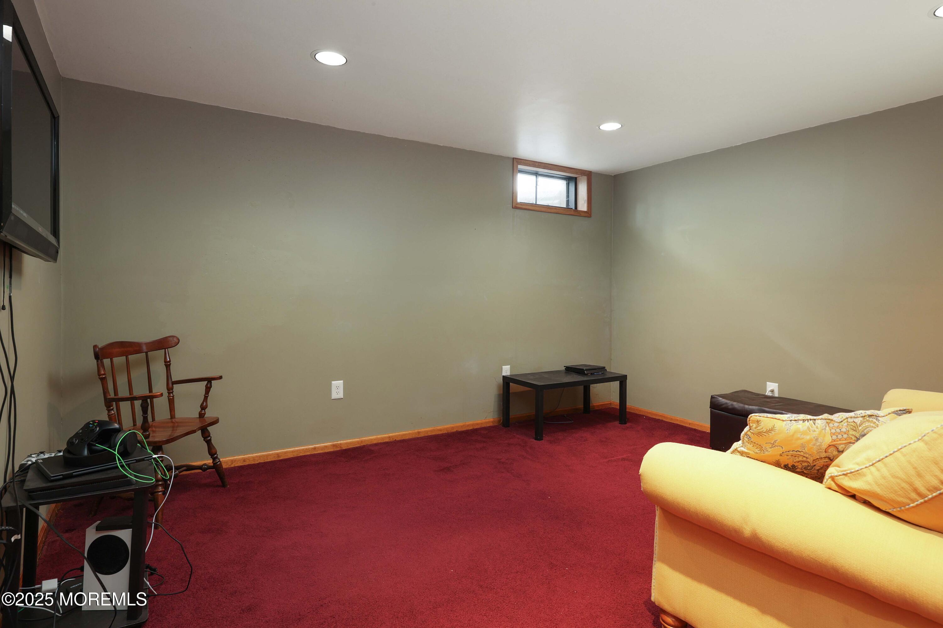 1 Exeter Pass Colts Neck, NJ 07722 - Photo 33 of 42 a living room with furniture and a flat screen tv