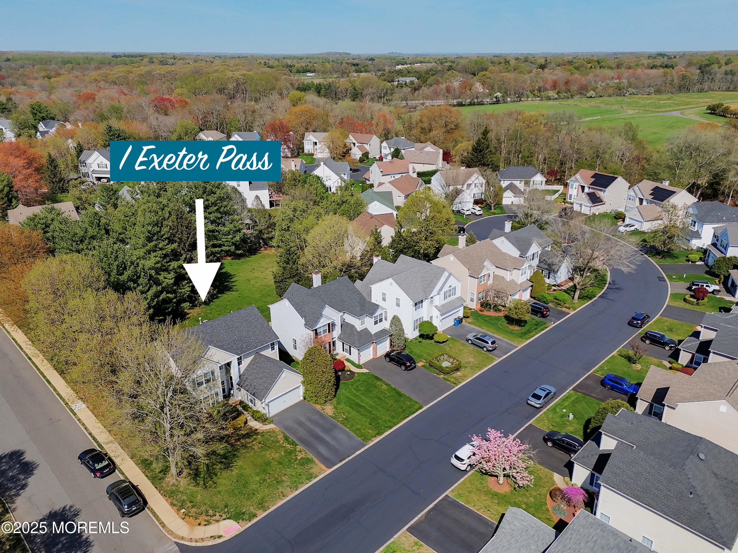 1 Exeter Pass Colts Neck, NJ 07722 - Photo 4 of 42 an aerial view of a house with a lake view
