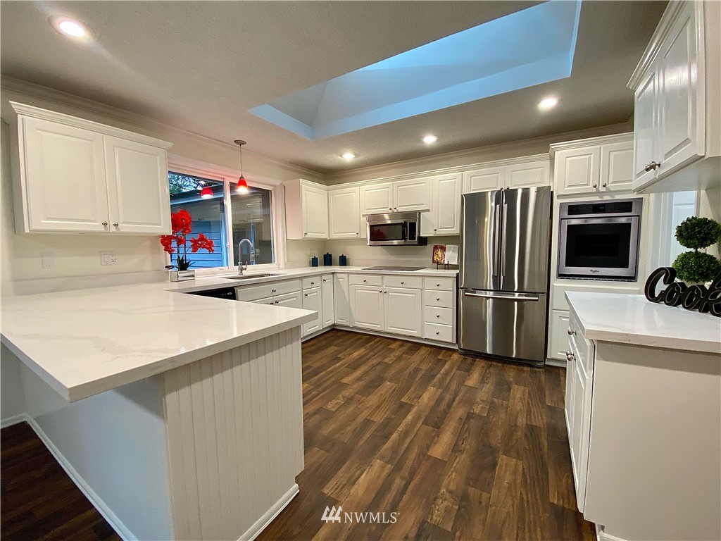 14902 175th Avenue Southeast Renton, WA 98059 - Photo 12 of 39 a kitchen that has a refrigerator and a sink