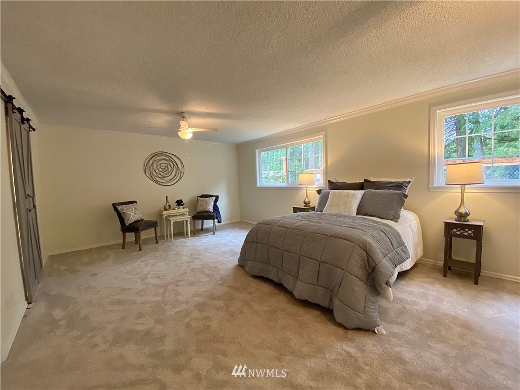 14902 175th Avenue Southeast Renton, WA 98059 - Photo 17 of 39 a spacious bedroom with a bed and window
