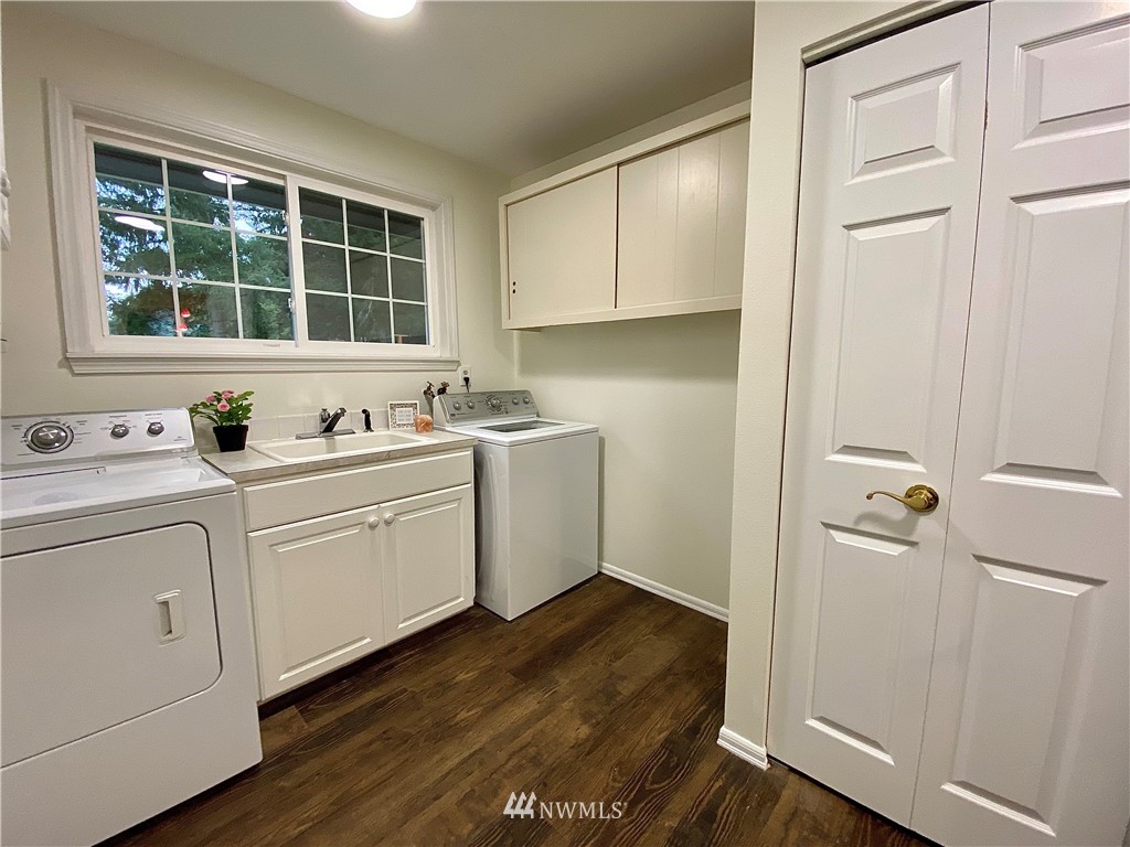 14902 175th Avenue Southeast Renton, WA 98059 - Photo 33 of 39 a room with a sink cabinets and a window