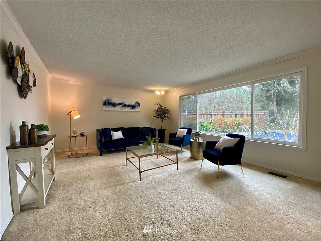 14902 175th Avenue Southeast Renton, WA 98059 - Photo 8 of 39 a living room with furniture and a floor to ceiling window