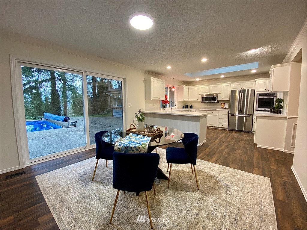 14902 175th Avenue Southeast Renton, WA 98059 - Photo 10 of 39 a living room with stainless steel appliances furniture a rug kitchen view and a large window
