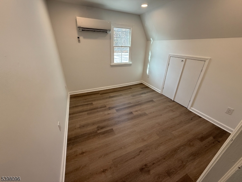 173 Highway 46, Unit 2A Mine Hill, NJ 07803 - Photo 6 of 7 an empty room with wooden floor and windows
