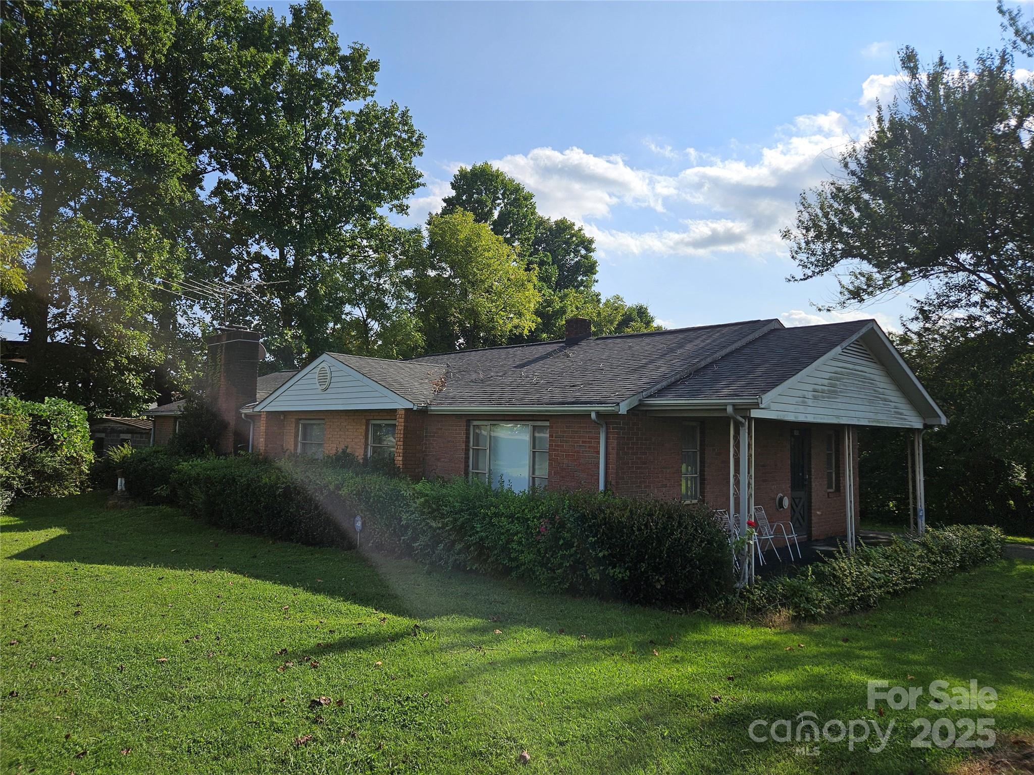 105 Marble Road Statesville, NC 28625 - Photo 3 of 5 a view of a house with a yard and a garden