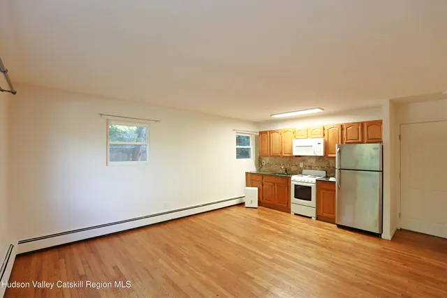 a view of a kitchen with a stove cabinets and wooden floor