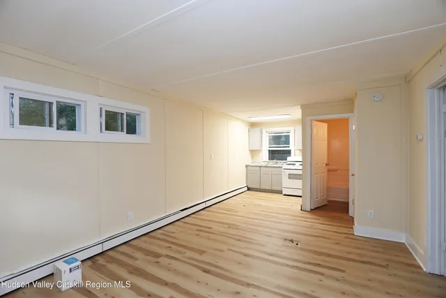 a view of a kitchen with wooden floor and a kitchen