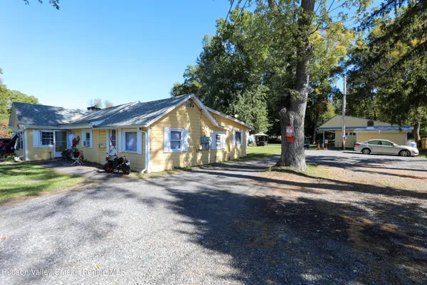 a view of a house with street next to a road