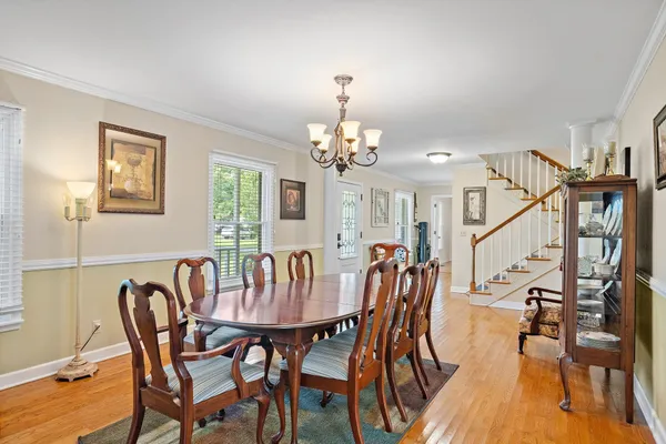 a view of a dining room with furniture and wooden floor