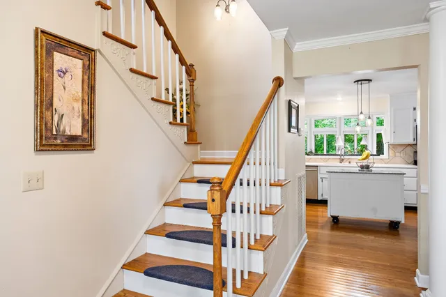 a view of entryway and hall with wooden floor