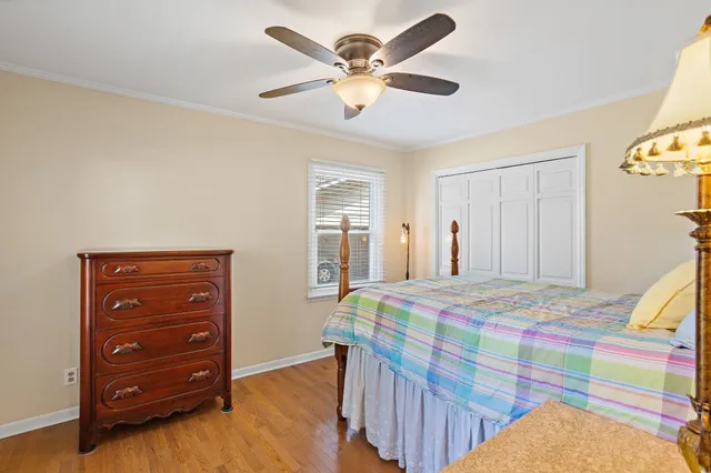 a bedroom that has a bed and a dresser in it