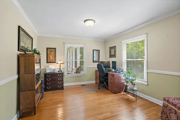 a bedroom that has a bed and a dresser in it