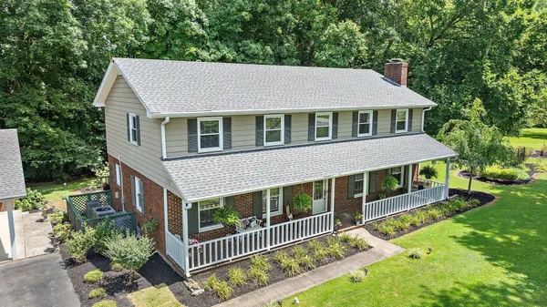 an aerial view of a house with a yard and outdoor seating