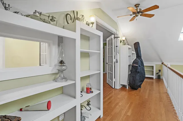 a room with gym equipment and wooden floor