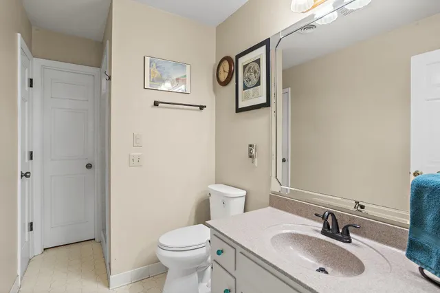 a bathroom with a sink toilet and vanity
