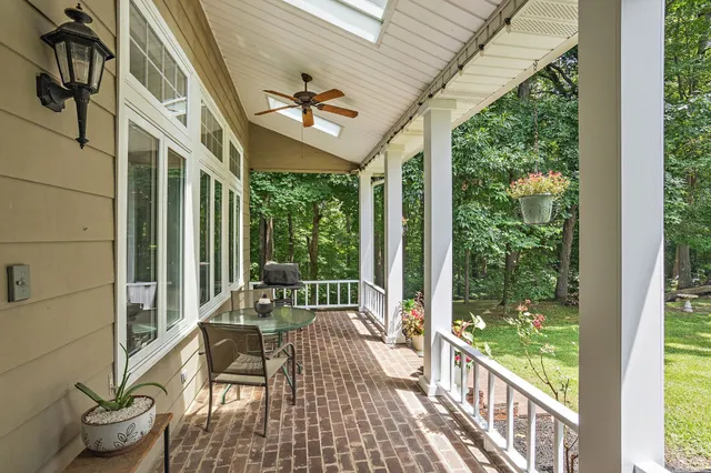 a view of a porch with chairs and backyard