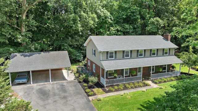 aerial view of a house with a yard table and chairs