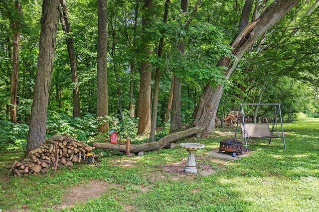 a view of a chair and table in the garden