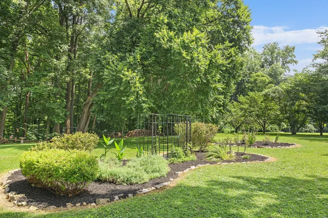 a backyard of a house with a yard and outdoor seating