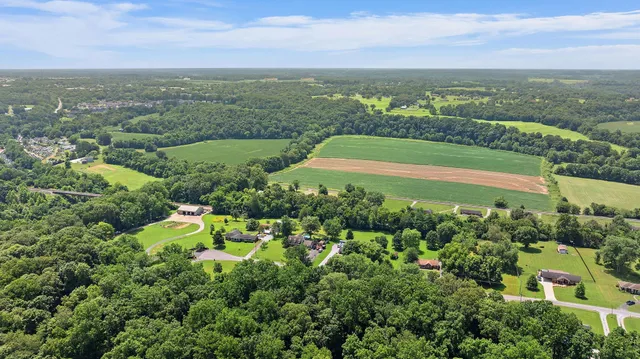 an aerial view of a city with lots of residential buildings ocean and mountain view in back