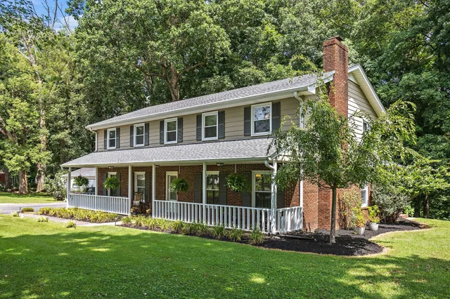 a view of a house with a yard and a garden