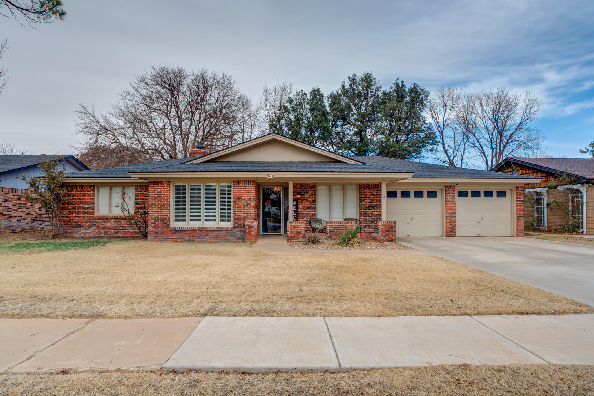 3410 76th Street Lubbock, TX 79423 - Photo 1 of 38 a front view of a house with garden