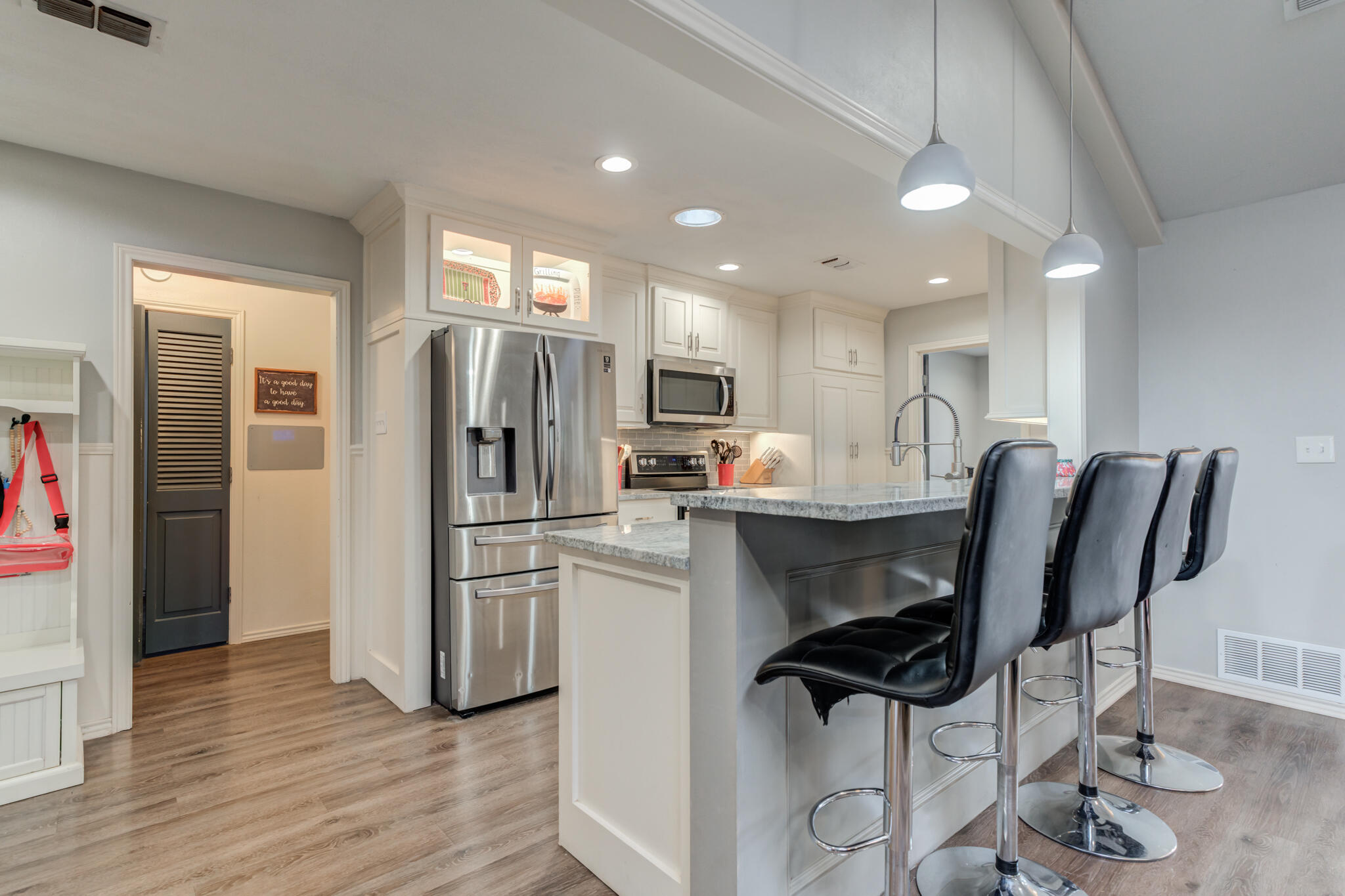 3410 76th Street Lubbock, TX 79423 - Photo 16 of 38 a kitchen with stainless steel appliances granite countertop a refrigerator and a stove top oven