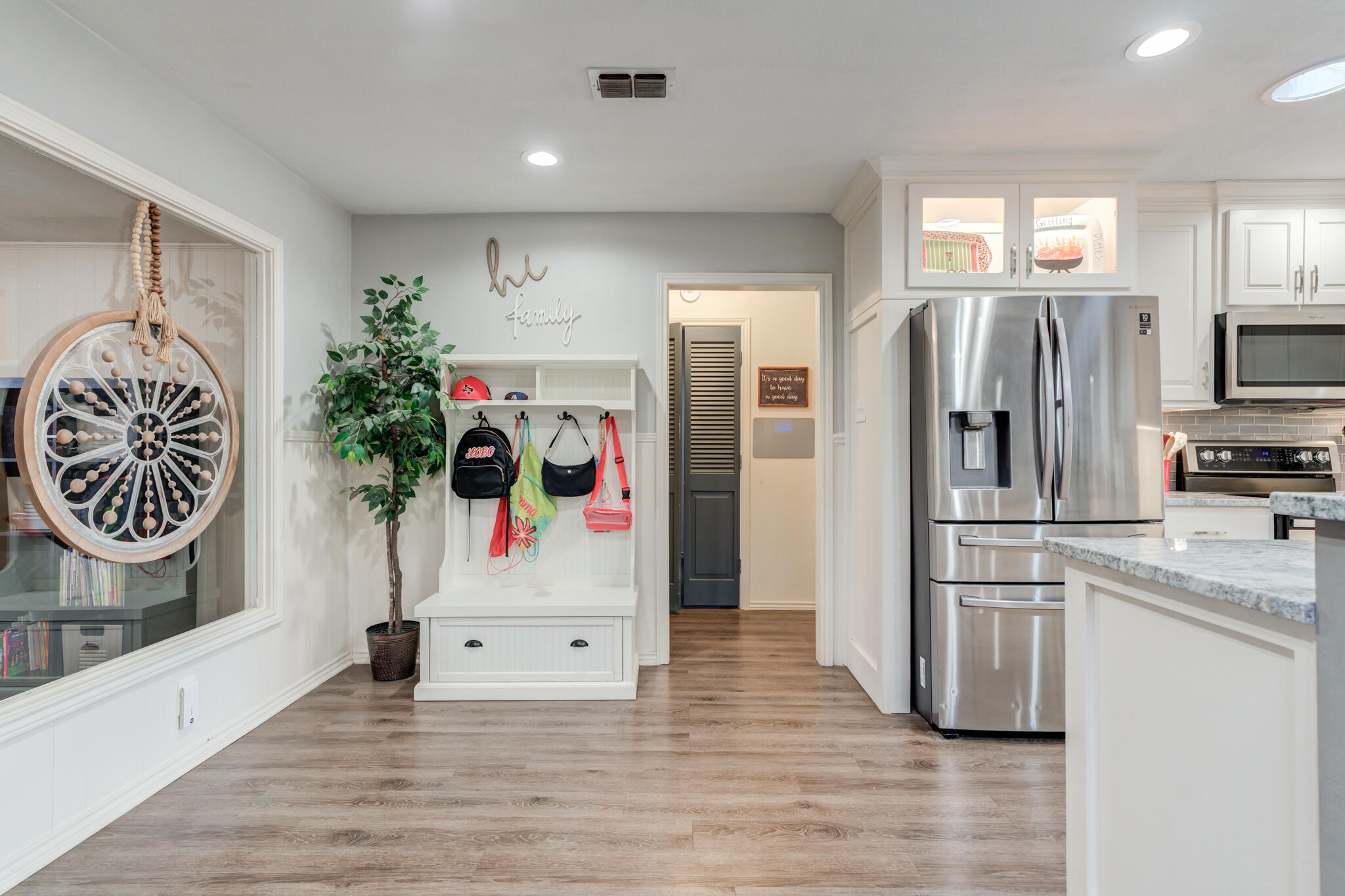3410 76th Street Lubbock, TX 79423 - Photo 17 of 38 a kitchen with granite countertop a refrigerator and a sink
