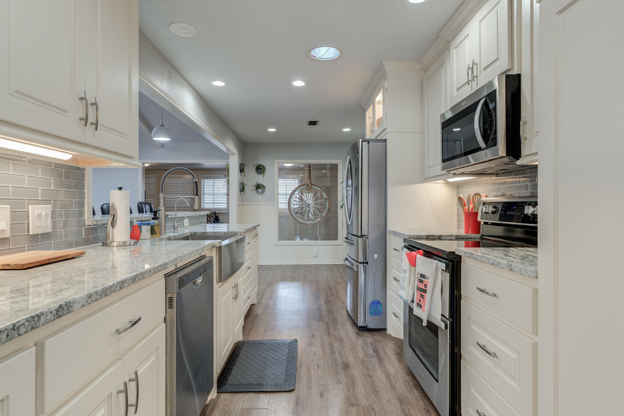 3410 76th Street Lubbock, TX 79423 - Photo 20 of 38 a kitchen with stainless steel appliances granite countertop a stove a sink and a refrigerator