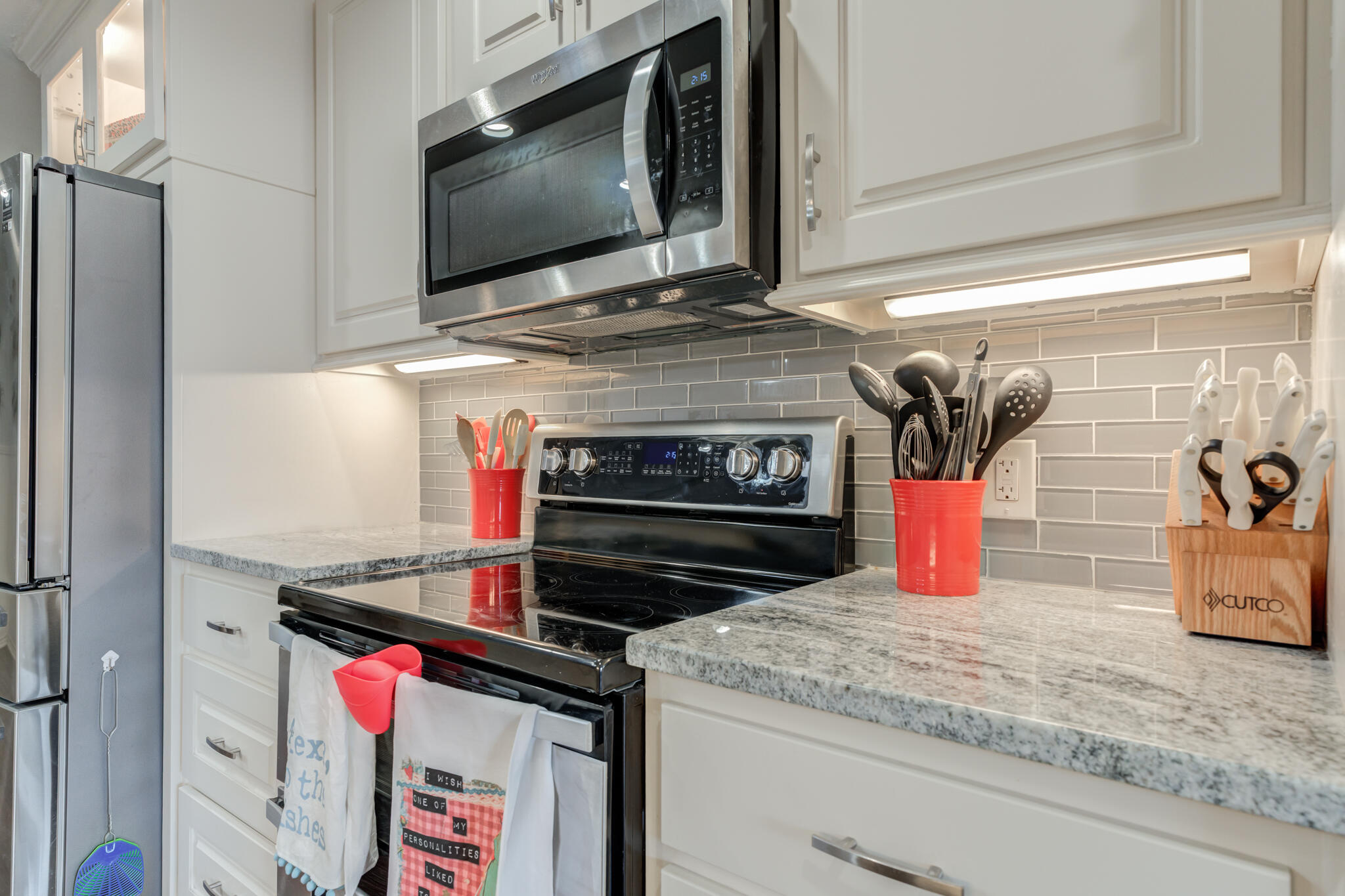 3410 76th Street Lubbock, TX 79423 - Photo 21 of 38 a kitchen with a stove and a microwave