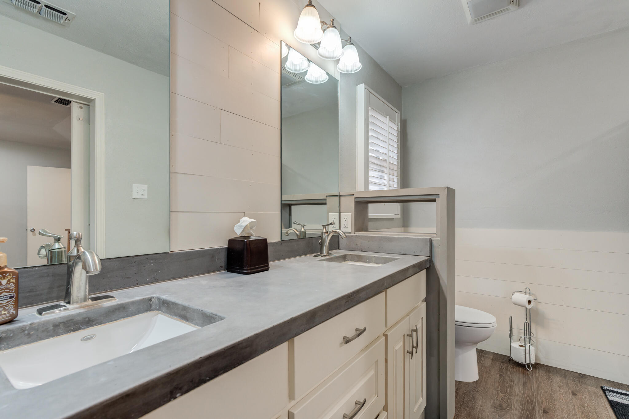 3410 76th Street Lubbock, TX 79423 - Photo 25 of 38 a bathroom with a granite countertop sink a toilet and a mirror