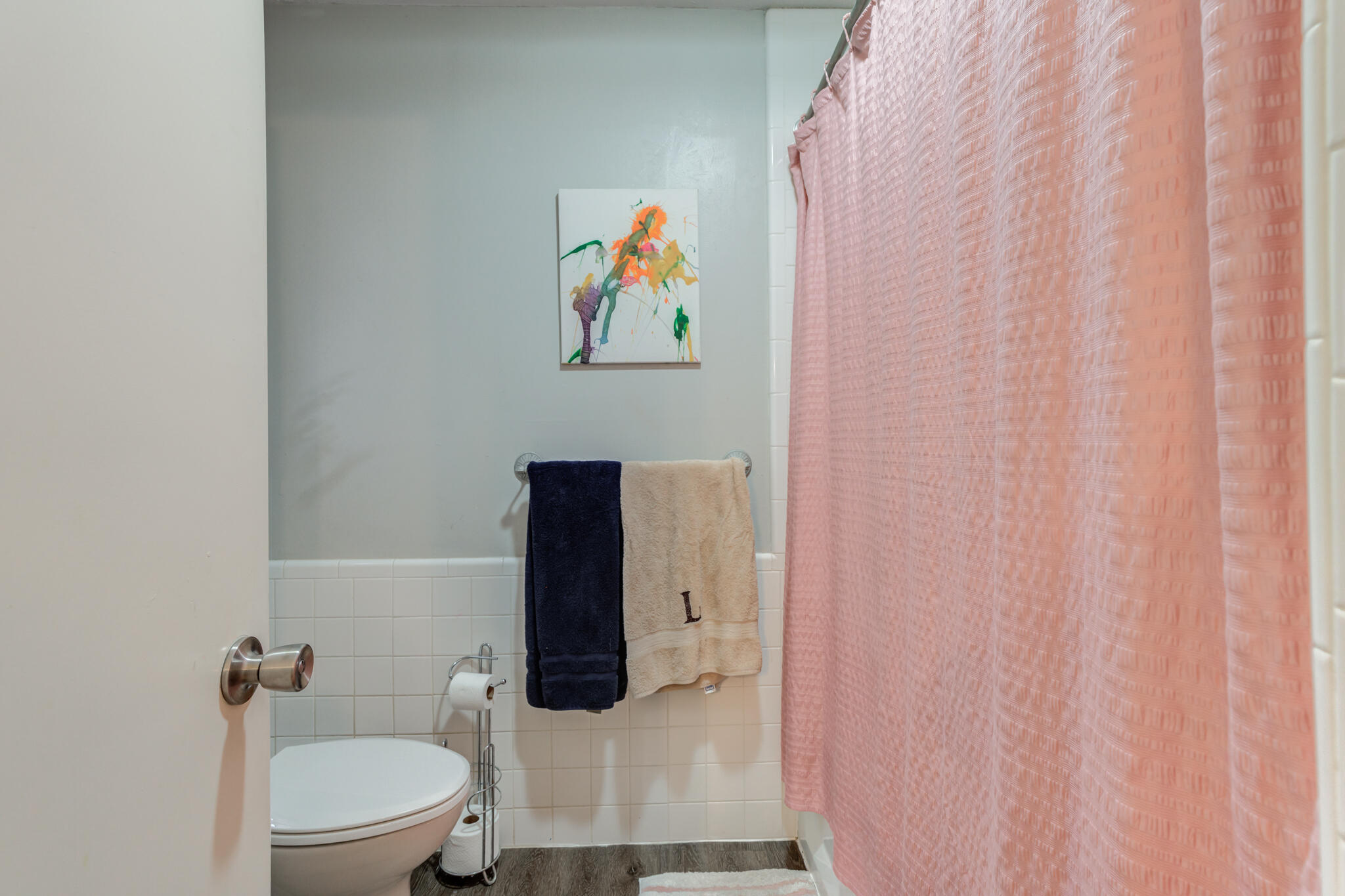 3410 76th Street Lubbock, TX 79423 - Photo 31 of 38 a bathroom with a toilet and a shower curtain