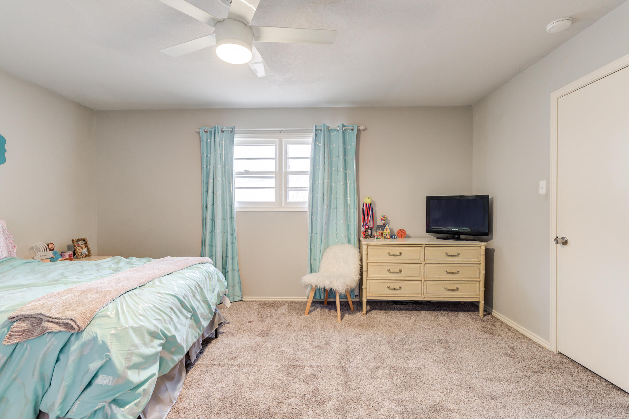3410 76th Street Lubbock, TX 79423 - Photo 32 of 38 a bed room with a bed and a television