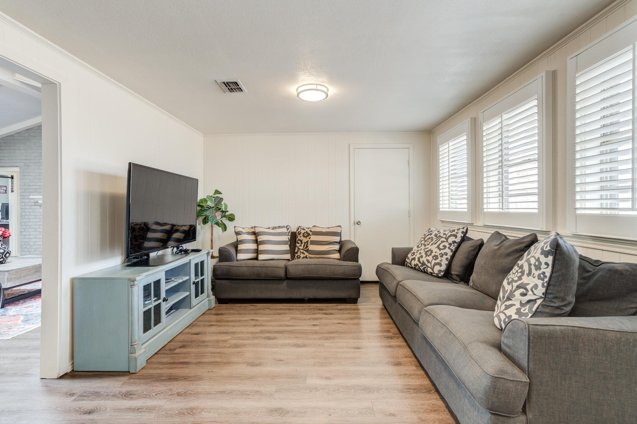 3410 76th Street Lubbock, TX 79423 - Photo 33 of 38 a living room with furniture and a flat screen tv