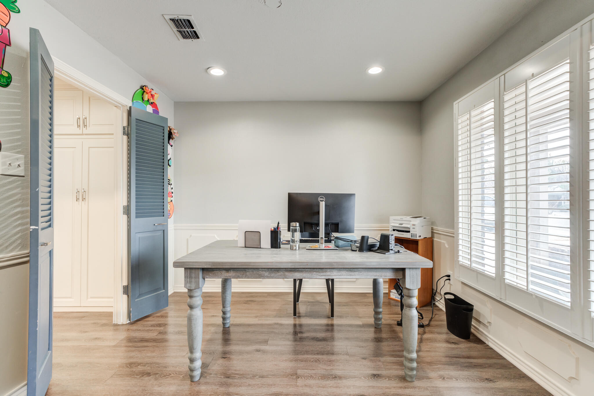 3410 76th Street Lubbock, TX 79423 - Photo 7 of 38 a view of a workspace with furniture and a window
