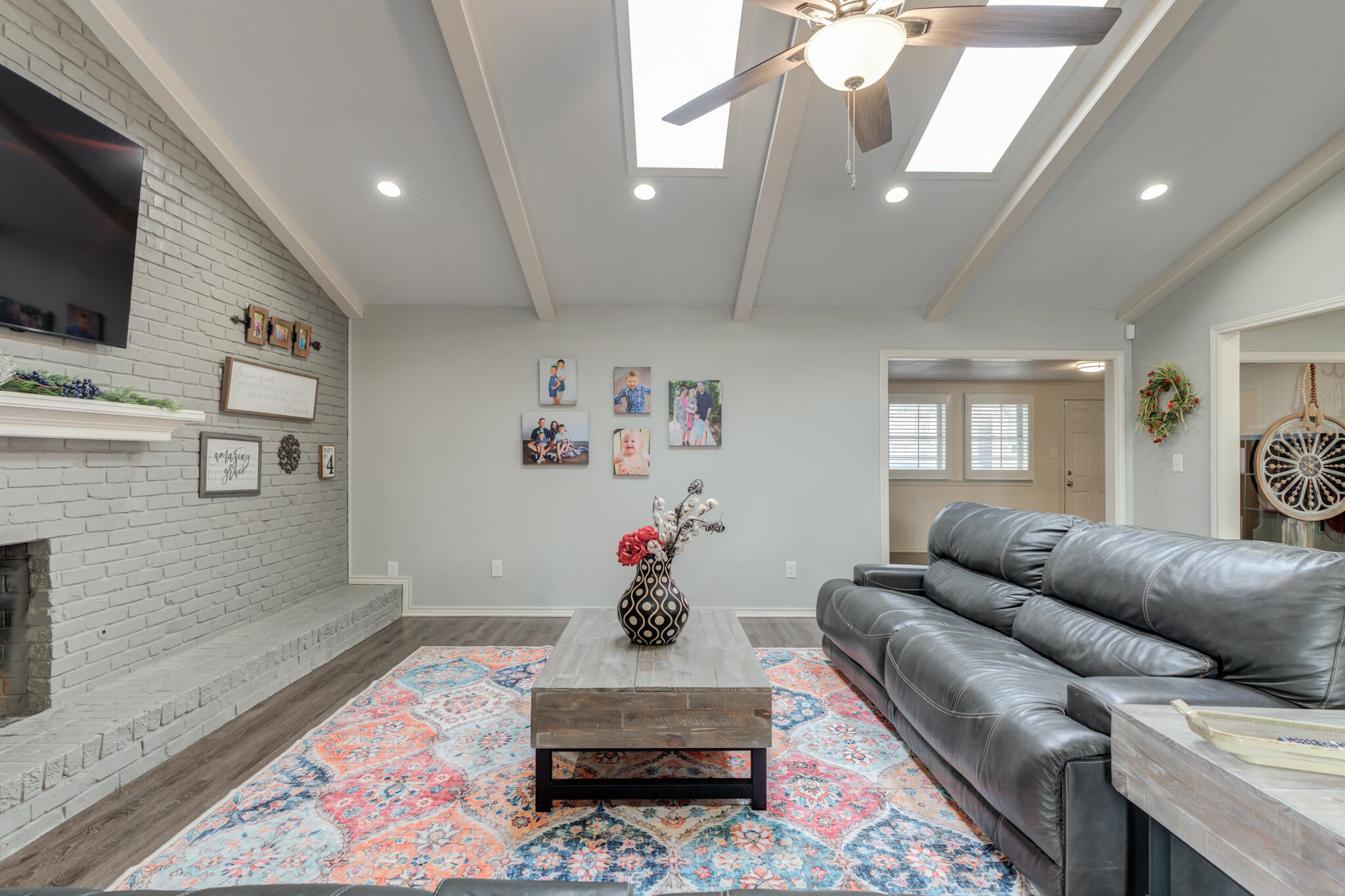 3410 76th Street Lubbock, TX 79423 - Photo 10 of 38 a living room with furniture and a flat screen tv