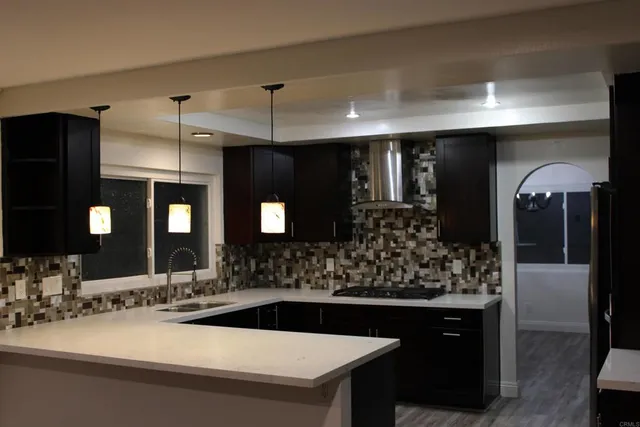 a kitchen with stainless steel appliances a refrigerator and a sink