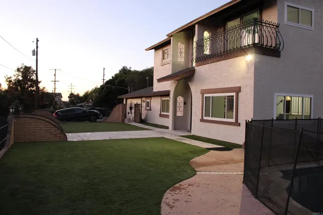 a front view of a house with a yard table and chairs
