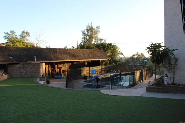 a view of a house with backyard porch and sitting area