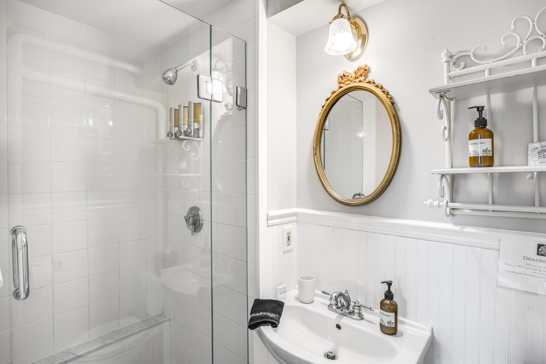 1861 Main Street Brewster, MA 02631 - Photo 22 of 65 a bathroom with a sink a mirror a bathtub and shower