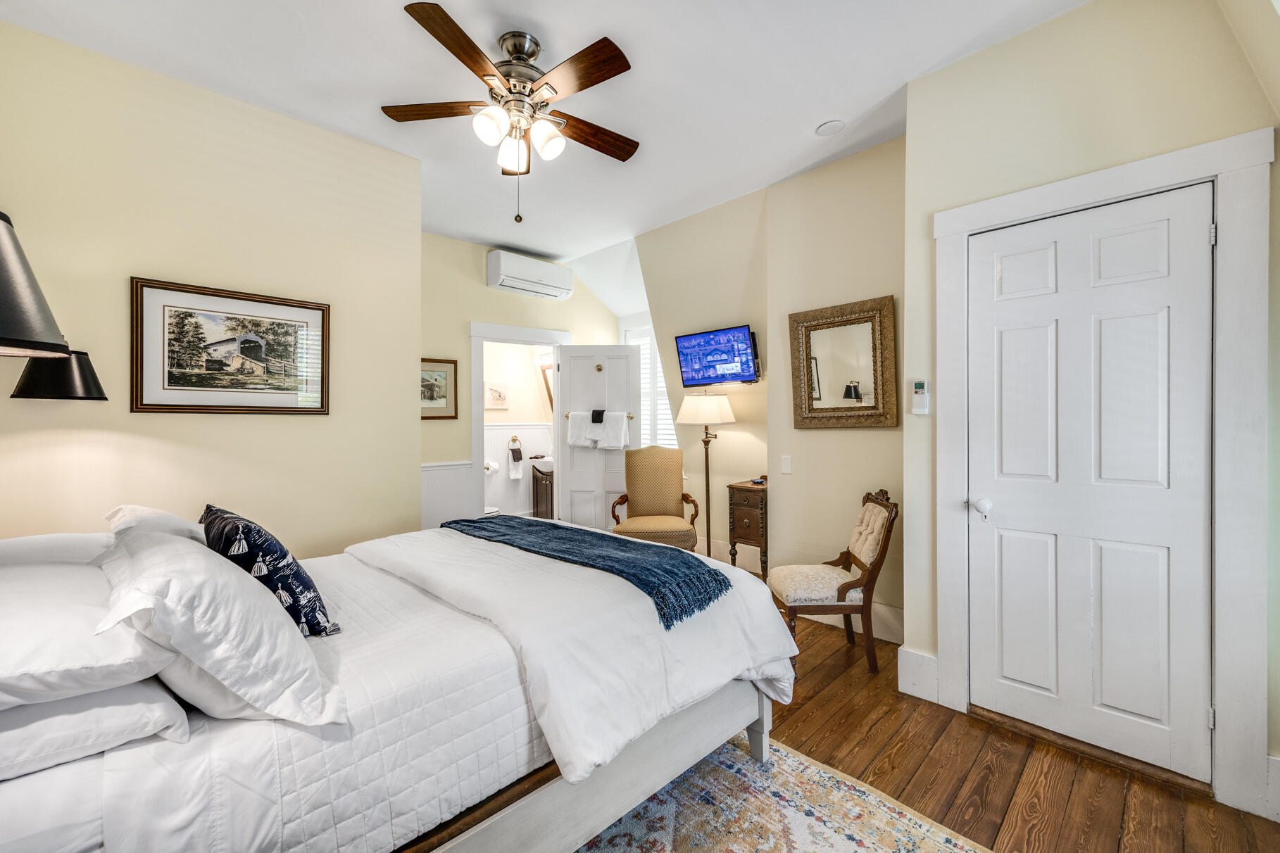 1861 Main Street Brewster, MA 02631 - Photo 32 of 65 a bedroom with a bed and a chandelier