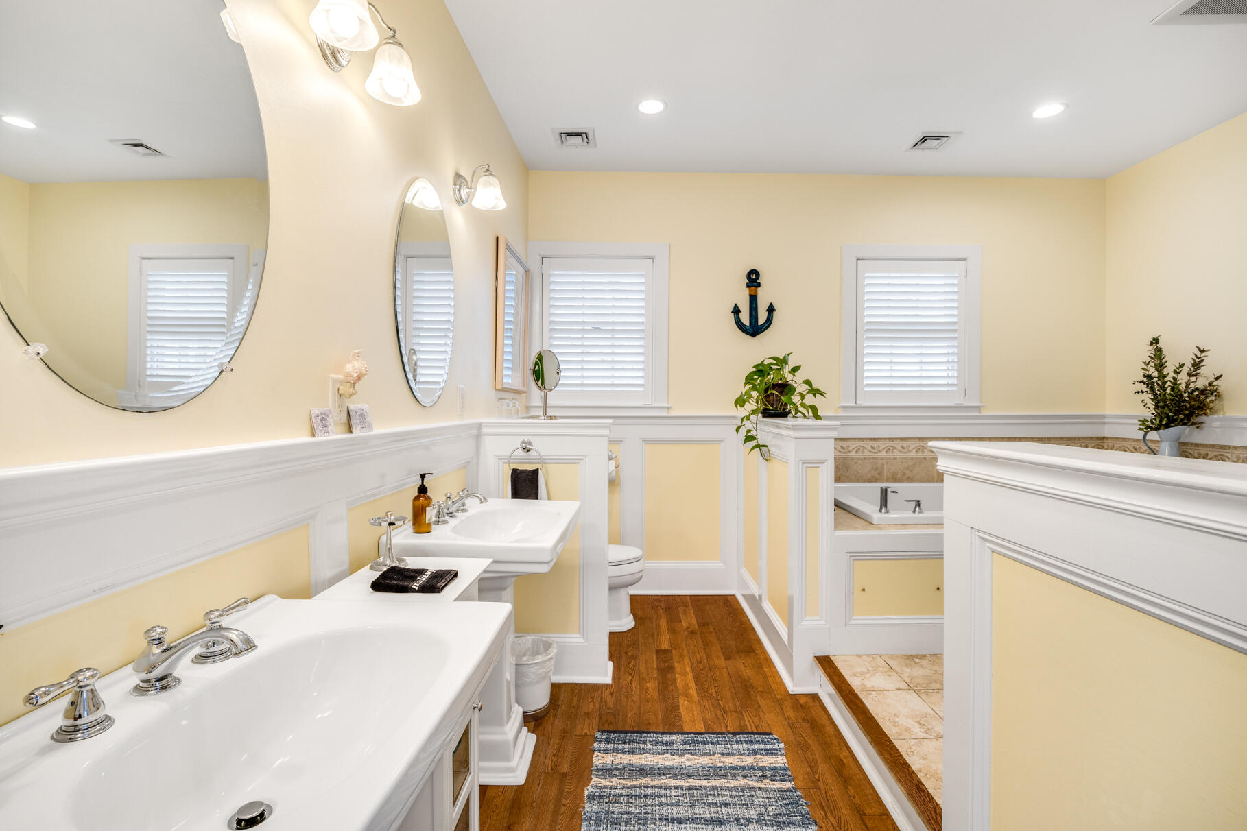 1861 Main Street Brewster, MA 02631 - Photo 41 of 65 a bathroom with a sink a mirror and a bathtub