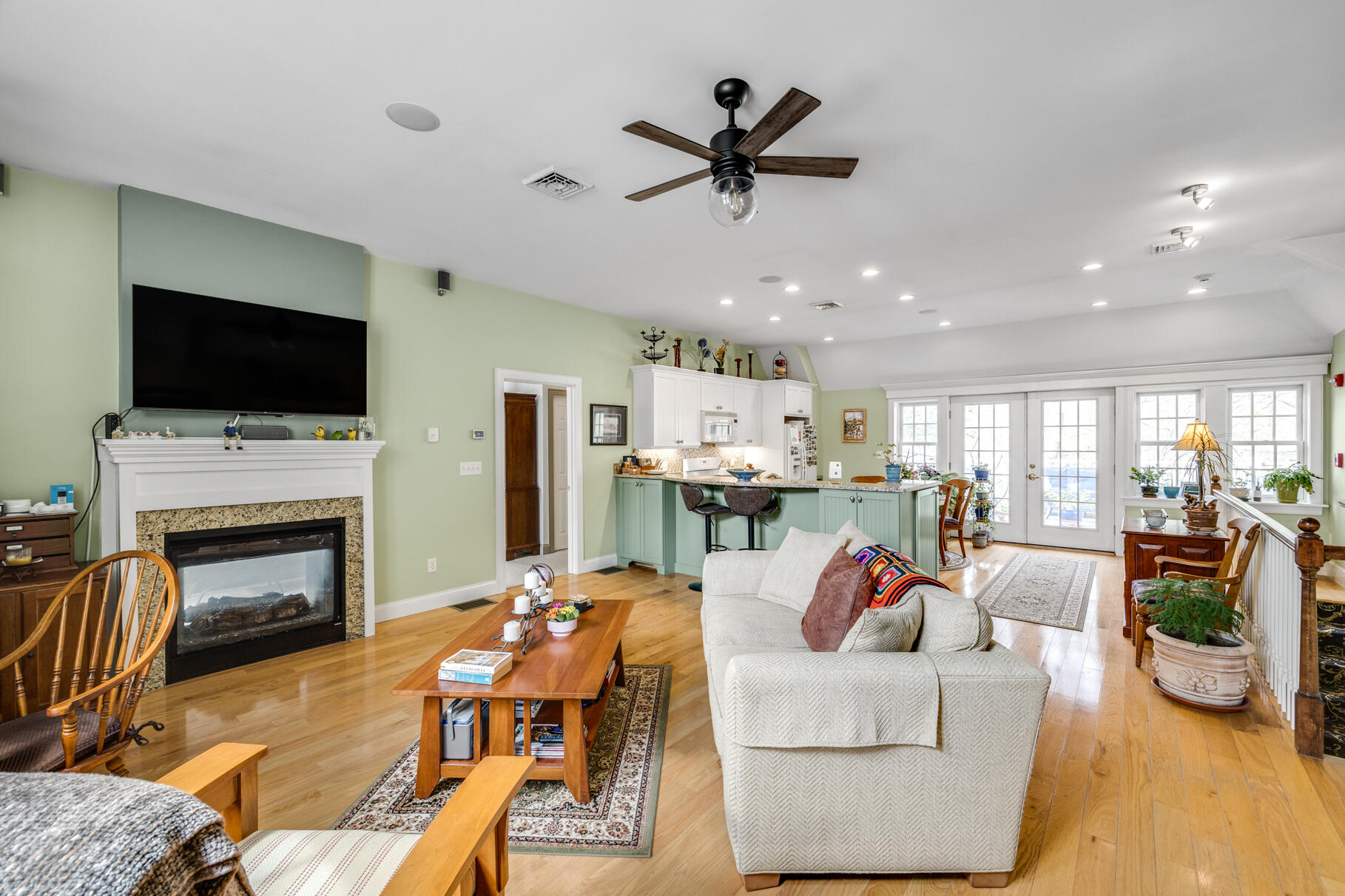1861 Main Street Brewster, MA 02631 - Photo 44 of 65 a living room with furniture a fireplace and a flat screen tv