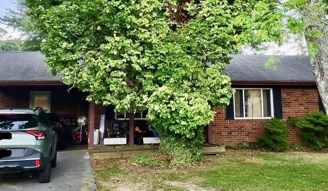 201 Church Street Decatur, TN 37322 - Photo 1 of 1 a view of a house with a small yard and a large tree