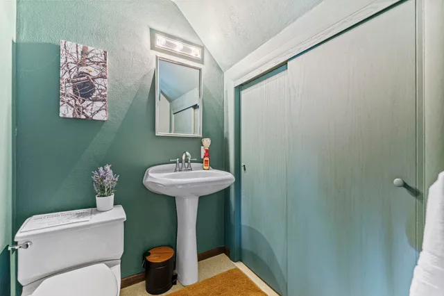 a dining room with furniture a chandelier and wooden floor